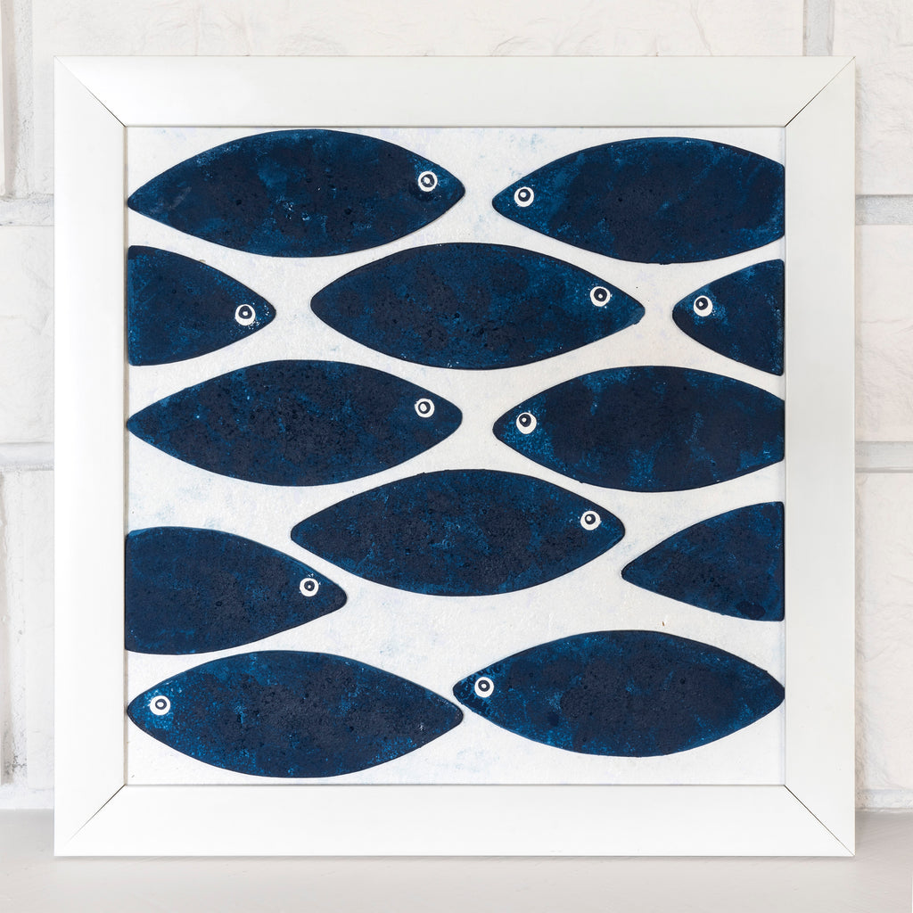 Blue Fish wall art shown front-facing in a white frame against a light neutral wall