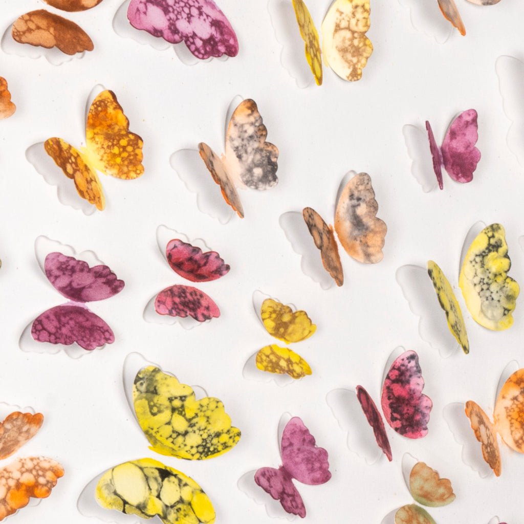 Close-up of hand-cut watercolor butterflies showing the layered 3D effect in Spring Flight wall art