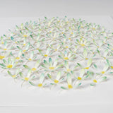 Close-up detail of layered paper daisies with soft green watercolor petals

