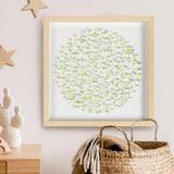 Square botanical daisy artwork styled on a wall above a woven basket
