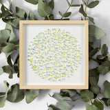 Framed 3D daisy wall art styled with eucalyptus leaves around the frame
