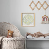 Handmade floral wall art displayed in a soft nursery interior
