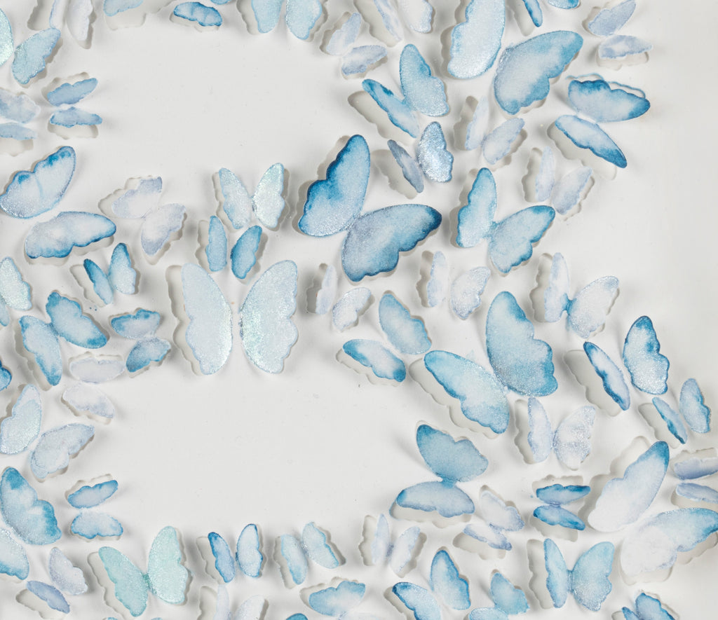 Close-up of hand-painted blue paper butterflies in the Blue Butterfly Letter B wall art