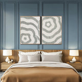 Textured abstract diptych wall art displayed above a bed in a calm modern bedroom