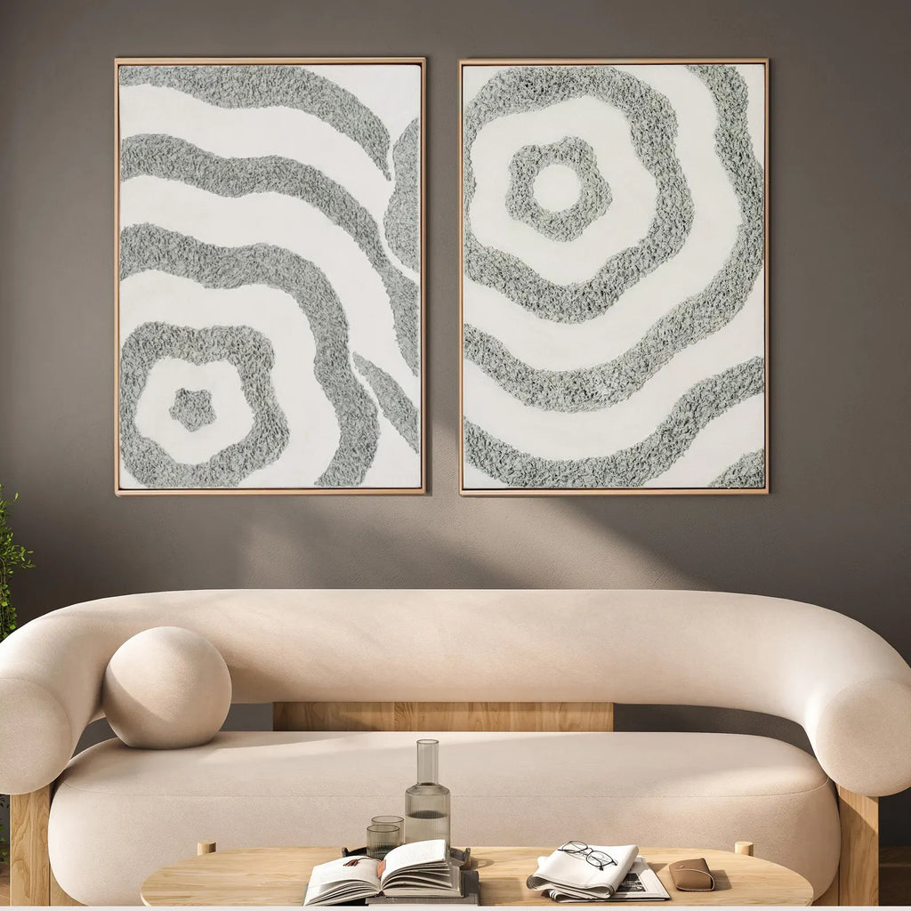 Neutral textured abstract canvas set of 2 styled above a curved sofa