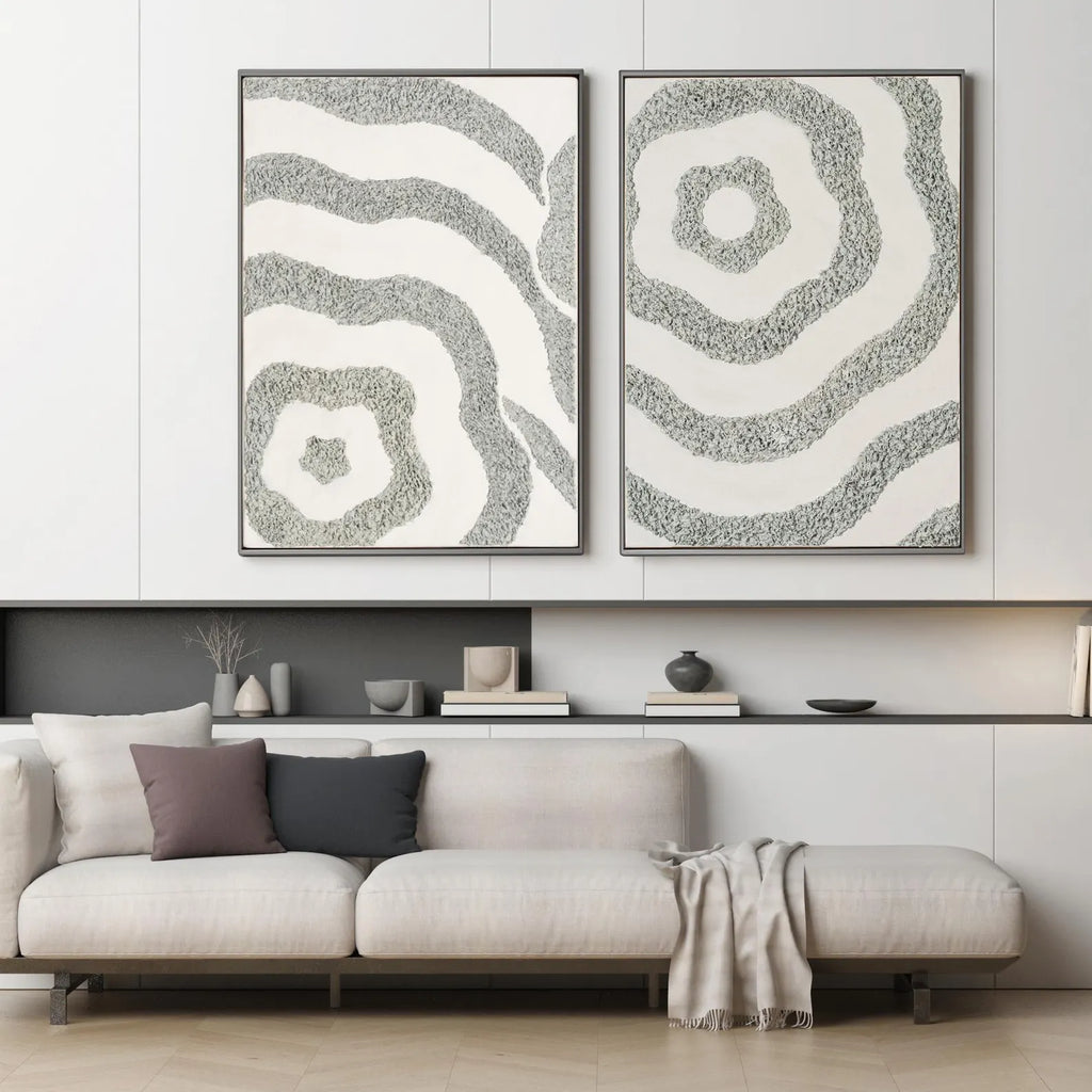 Textured abstract canvas set of 2 in sage grey tones displayed above a modern sofa