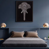 Textured elephant wall art styled above a bed in a dark modern bedroom