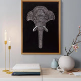 Handmade elephant relief canvas displayed above a console with elegant decor