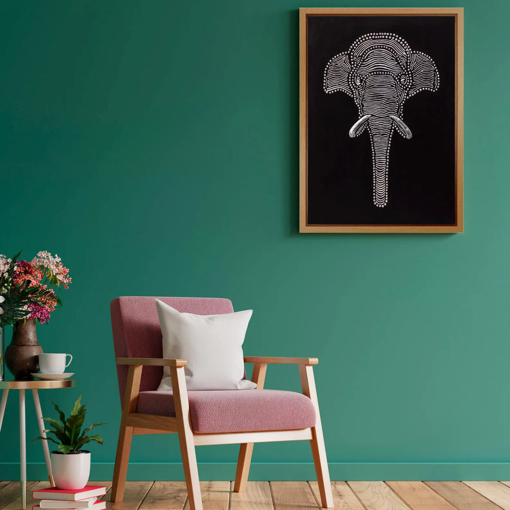 Handmade elephant relief canvas displayed on a green accent wall