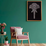 Handmade elephant relief canvas displayed on a green accent wall