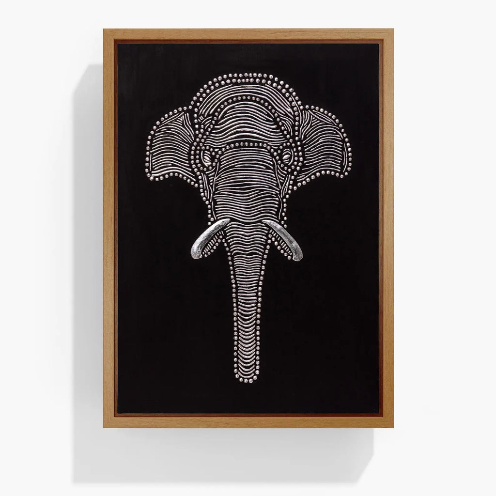 Textured elephant wall art in a natural wood frame on a black canvas background