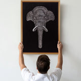 Large textured elephant wall art shown being held for hanging scale reference