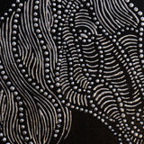 Close-up detail of textured horse relief canvas with metallic finish