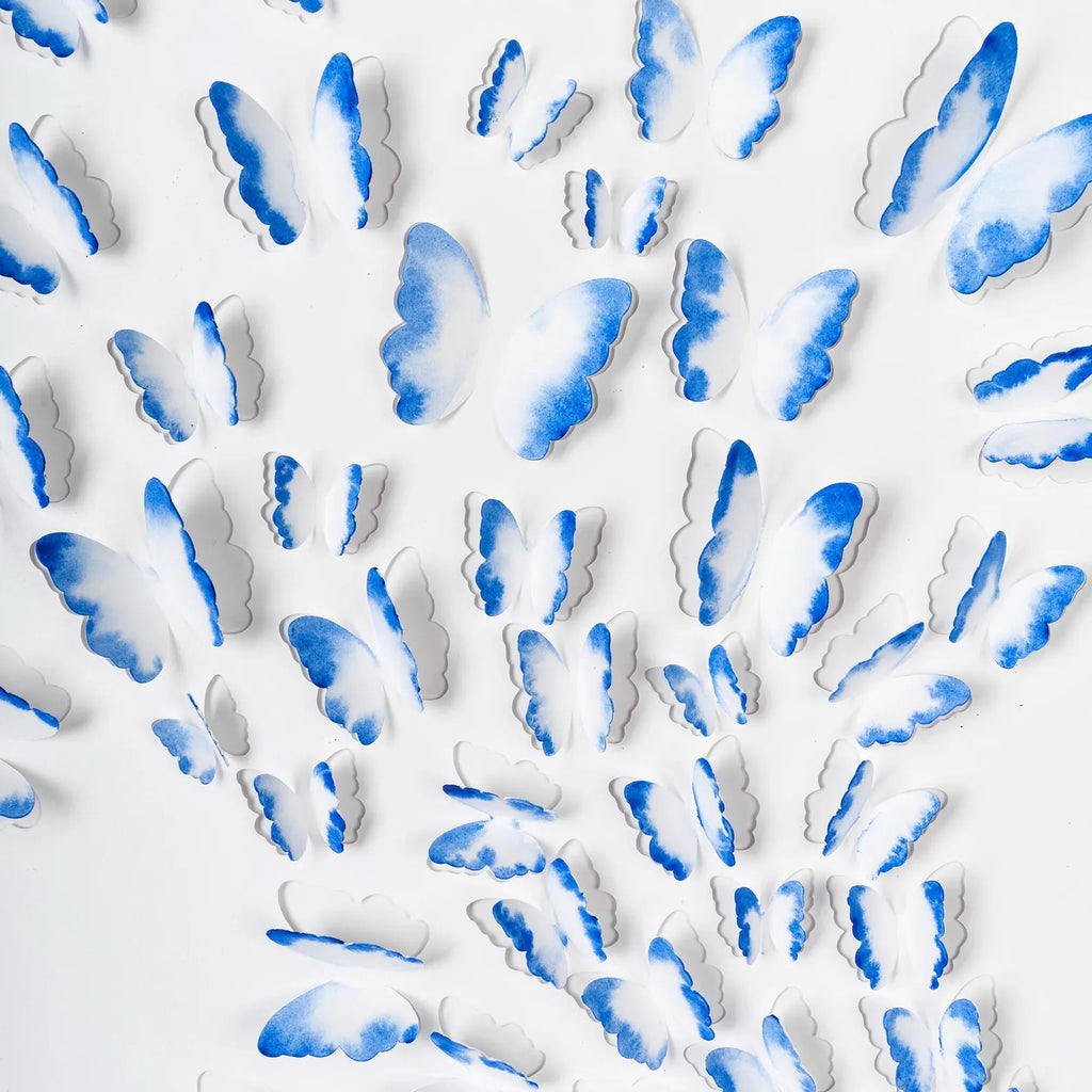 Close-up detail of hand-painted blue 3D paper butterflies arranged in a dimensional composition