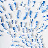 Close-up detail of hand-painted blue 3D paper butterflies arranged in a dimensional composition