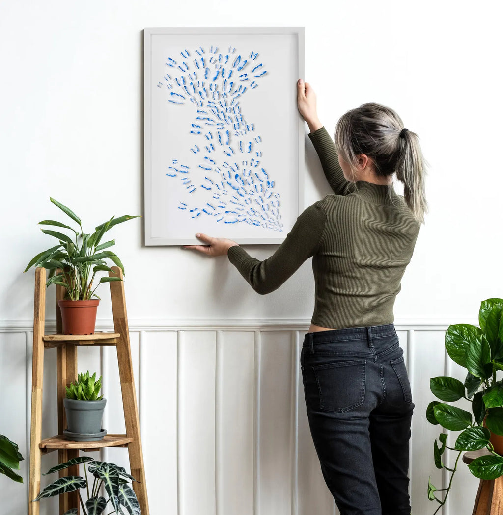 Scale view of Blue Butterfly Wall Art being placed on a wall in a bright interior