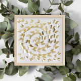 Gold Butterfly Spiral Wall Art styled with eucalyptus leaves on a clean background