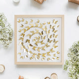 Gold Butterfly Spiral Wall Art photographed in a floral flat lay composition