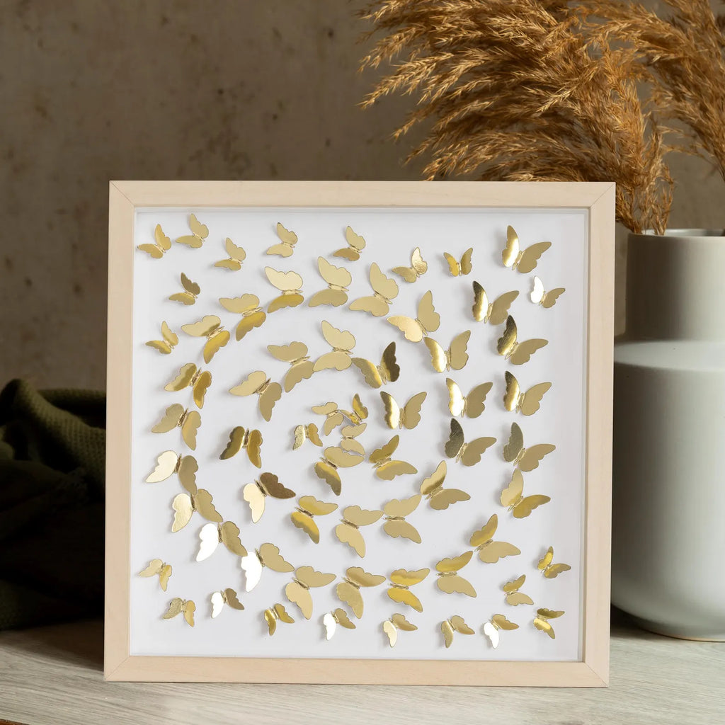 Gold Butterfly Spiral Wall Art styled in a warm interior with natural textures
