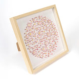 Pink Daisy Circle Wall Art styled in a warm interior with natural textures