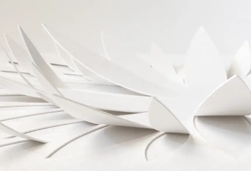 Close-up of pre-cut 3D watercolor paper details lifted to create a dimensional paper art design.