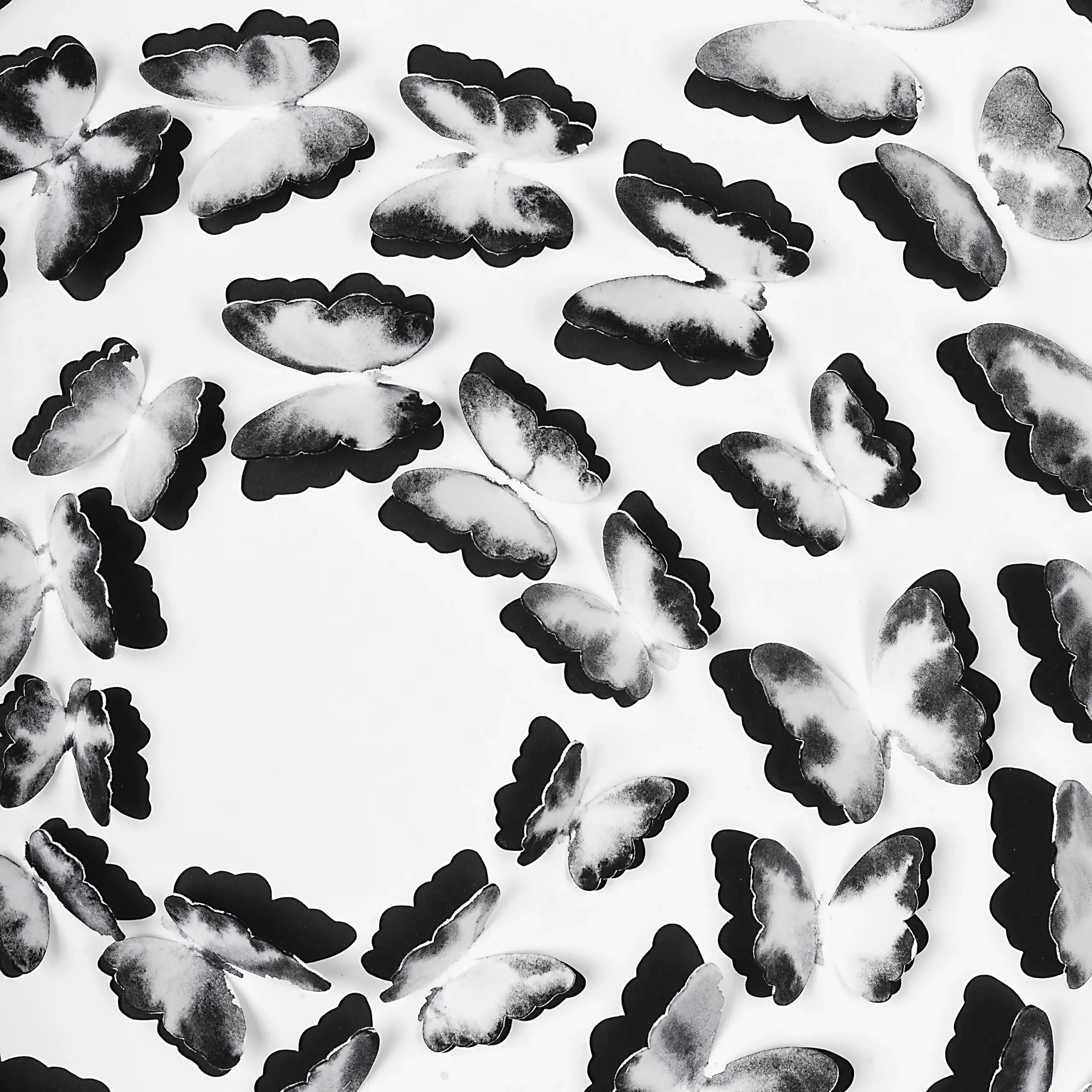 Close-up of hand-painted black and white paper butterflies in the Black and White Butterfly Spiral artwork