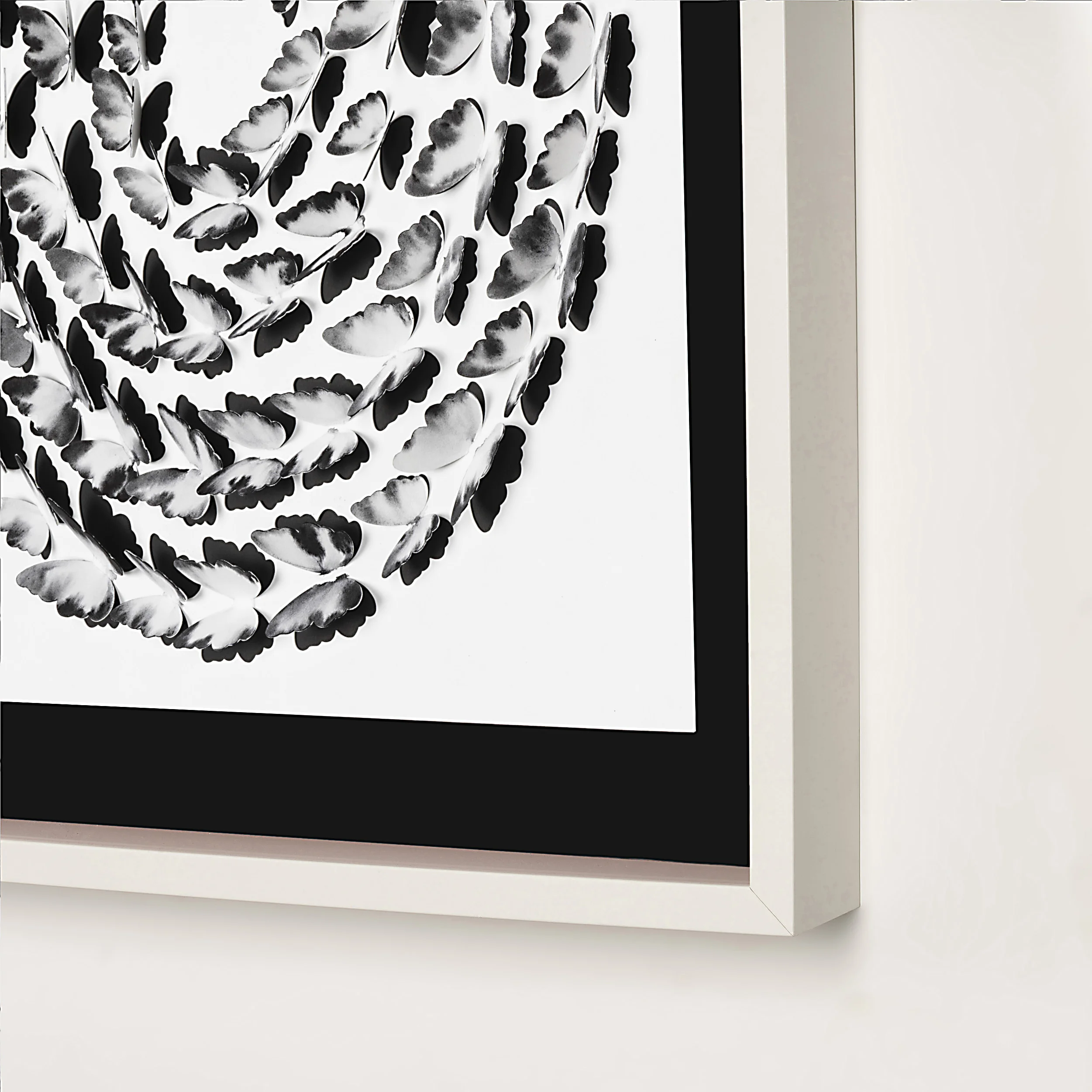 Close-up of Black and White Butterfly Spiral wall art showing the frame, black mat, and layered butterfly details