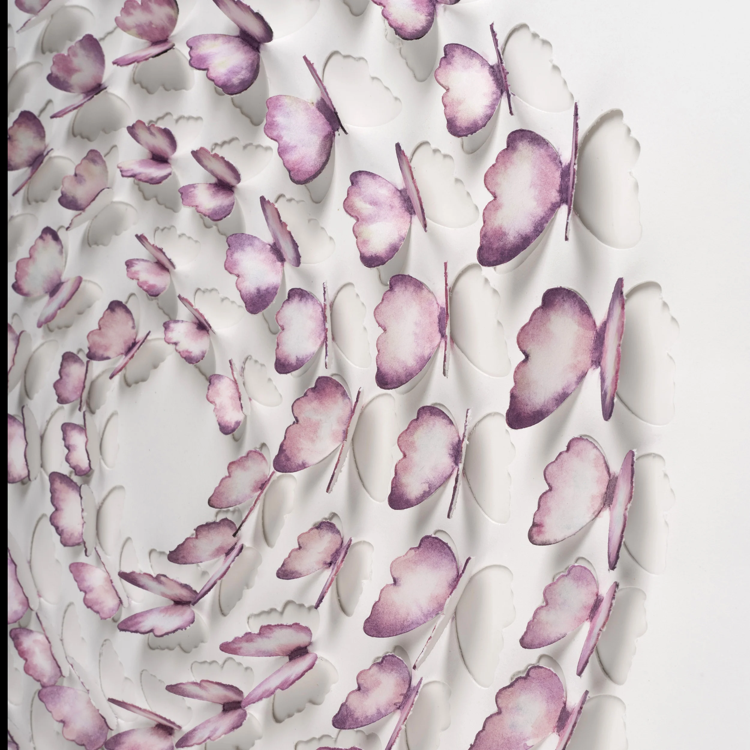 Close-up of hand-painted pink paper butterflies showing the layered 3D effect in the shadow box artwork