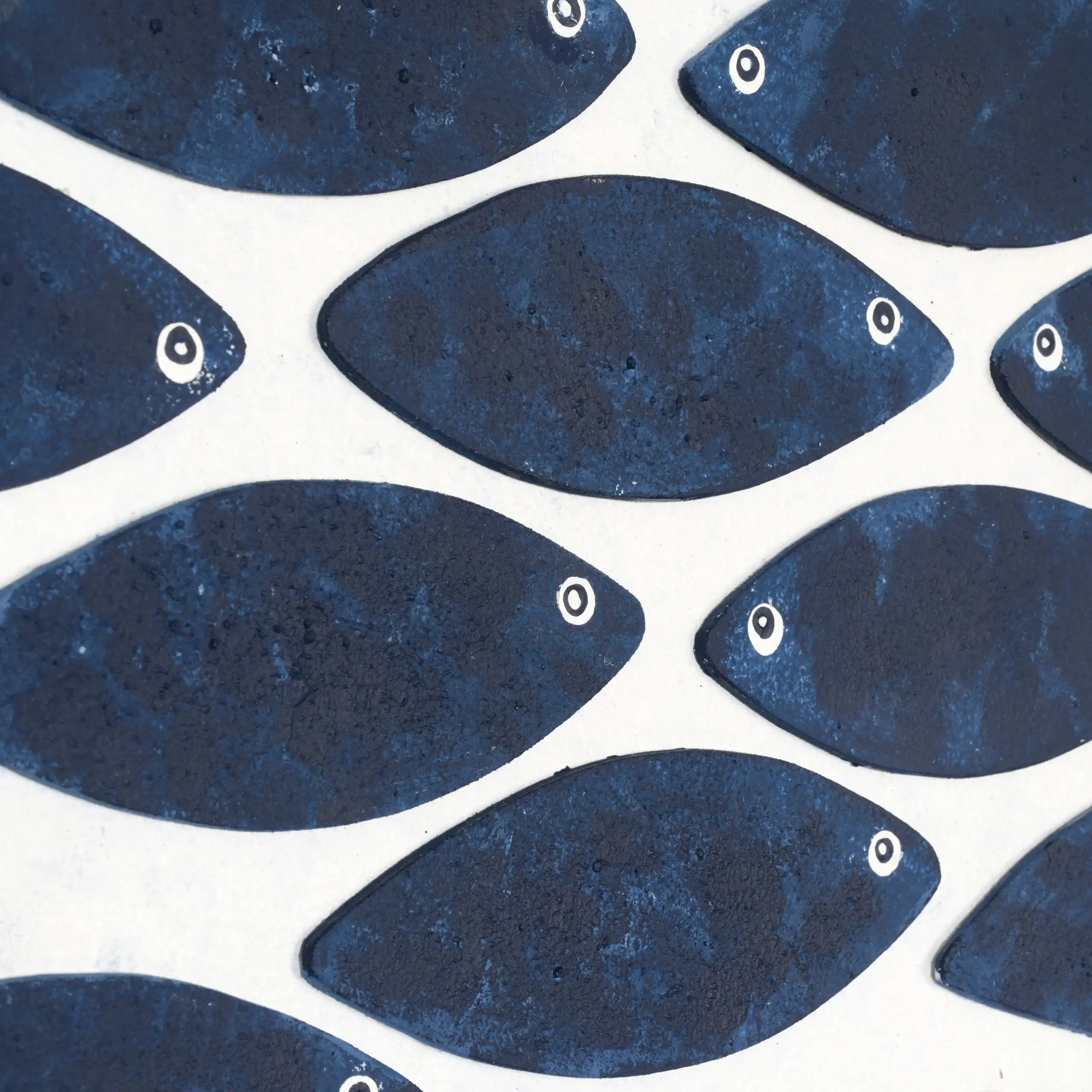 Indigo blue fish wall art styled in a bright living room with plants and neutral home decor