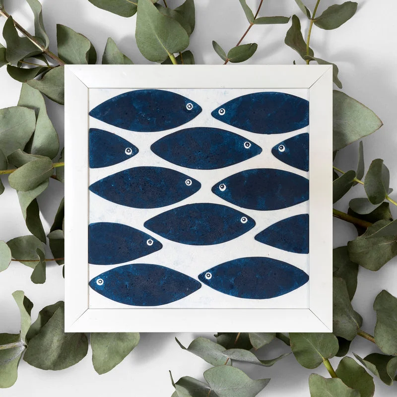 Indigo blue fish wall art in a white square frame, shown from the front with layered fish details