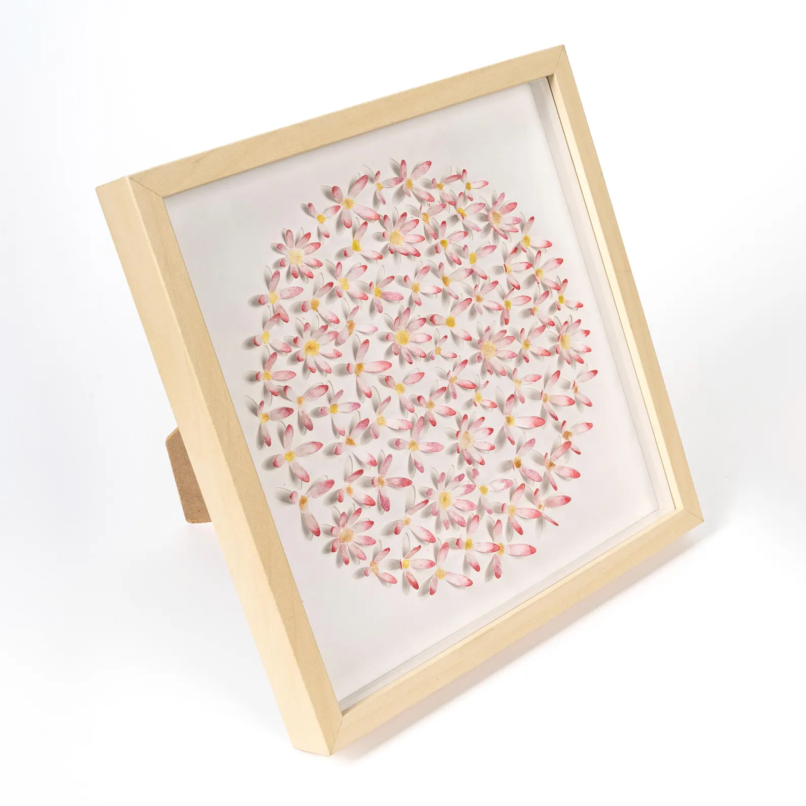 Pink daisy circle 3D watercolor wall art displayed in a warm neutral interior with soft home decor